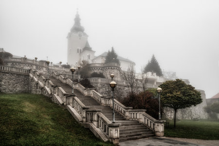 Ruzomberok, Slovakia - November 1, 2022:Foggy autumn morning and stairs to the churh in town Ruzomberokのeditorial素材