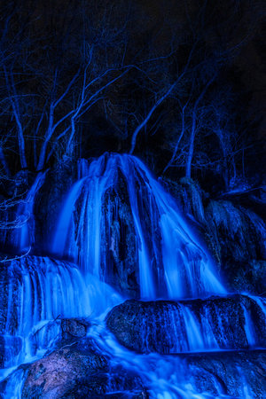 illuminated waterfall Lucky with blue light at night. Slovakia.の写真素材