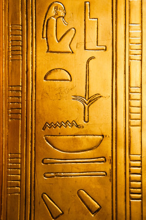 Egyptian hieroglyphics on golden plate from king Tutankhamun tomb.