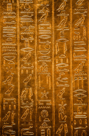 Egyptian hieroglyphics on golden plate from king Tutankhamun tomb.
