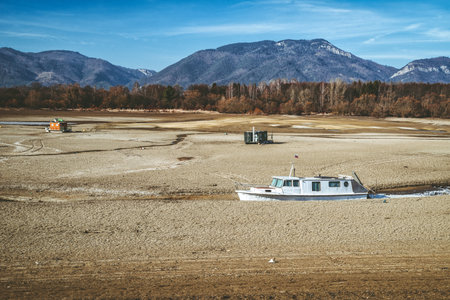 Liptovsky Trnovec, Slovakia - February 21, 2025: Boats on a drought lake without waterの写真素材