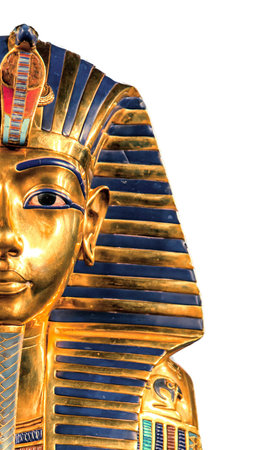 Vertical close-up showing half of Tutankhamunâs golden funerary mask with deep blue stripes, colorful inlays and cobra emblem, isolated on white background for creative ancient Egyptian art design.の写真素材