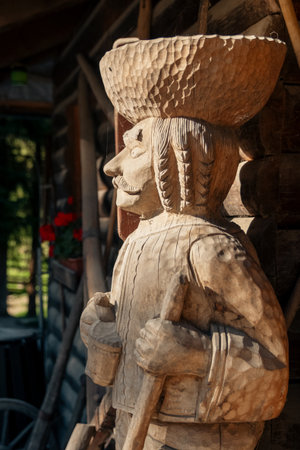 Ruzomberok, Slovakia - October 25, 2004: Wooden folk statue standing outside a rural house in Cutkovska dolina, illustrating traditional wood carving, village life and cultural heritage of the Liptov region.のeditorial素材