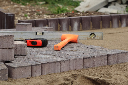 Laying paving stones. Paving tools for use.