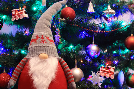 Christmas gnome standing on the background of the Christmas tree