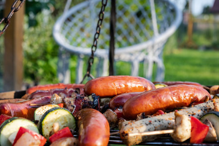 Barbeque with grilled sausages and vegetables on the grillの写真素材