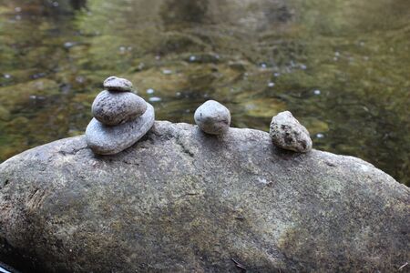 Stones stacked on top of each other by the river.の写真素材