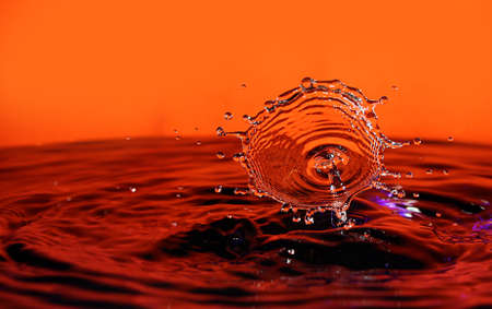 Water drops creating a splashの写真素材