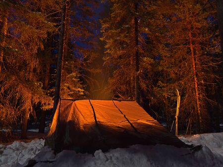 Sleeping in Finnish lean-to shelter Laavu in winter taiga forest.の写真素材
