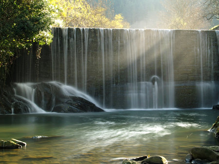 A scenic waterfall stream in silky effect.の写真素材