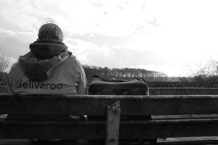 Utrecht, the Netherlands, February 19, 2019: Deliveroo person, waiting alone for the next order with a beautiful viewのeditorial素材