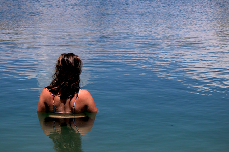 Young, beautiful woman model standing in a lake on holiday in Spain. without skyの写真素材