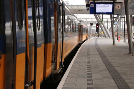 Intercity, a yellow train, with the doors open ready to enter