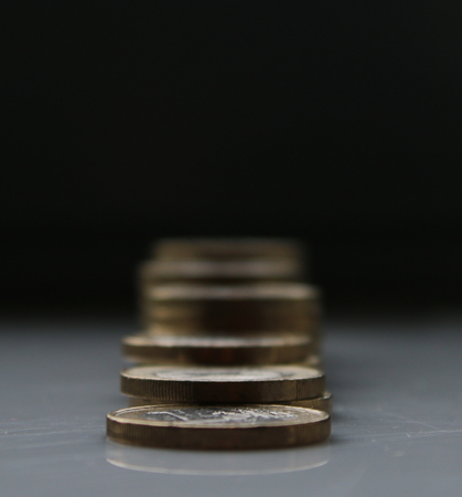 Euros stacked in piles and becoming blurry after the first pileの写真素材