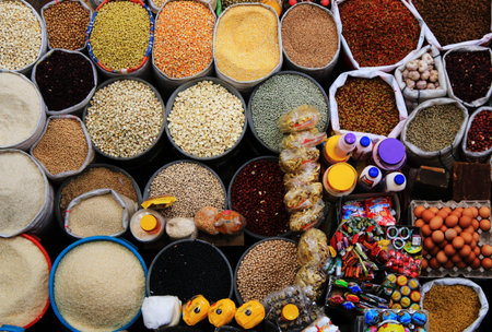 Colourful background of many different types of seeds, rice, corn, eggs and candy