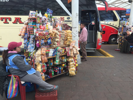 Quito, Ecuador - 14-7-2019: People selling fruits, drinks and candy in front of the leaving busesのeditorial素材