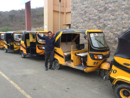 Puerto Lopez - Ecuador 3-5-2019: A line of yellow tuktuk taxis waiting for passengersのeditorial素材
