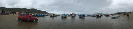 Puerto Lopez, Ecuador, 9-7-2019: the many fishing boats, people and birds in the harbourのeditorial素材