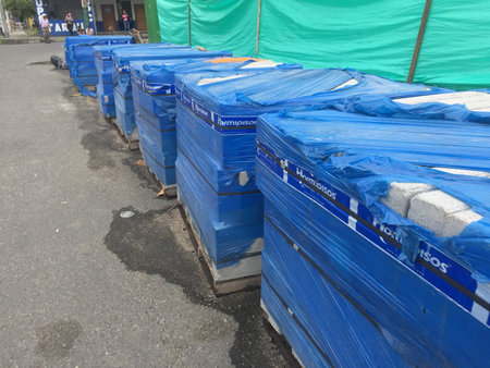 Puyo - Ecuador , 18-9-2019: Large row of piled bricks covered with a blue plasticのeditorial素材