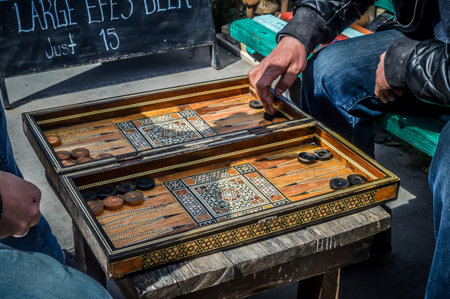 Play checkers outdoors