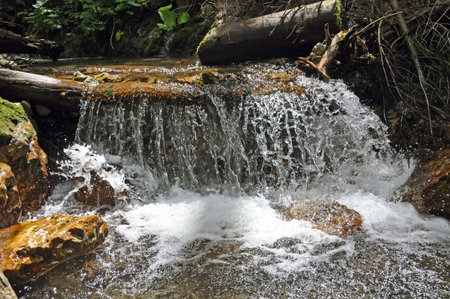 A wide, low waterfall in the Great Sokol gorge in Slovak Paradise.の写真素材