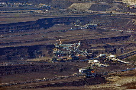 The interior of the workings of an open-pit lignite mine in Belchatow, with several working machines - mining combines. Poland.の写真素材