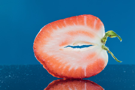 Slice Strawberry on a Dark Blue Backgroundの写真素材