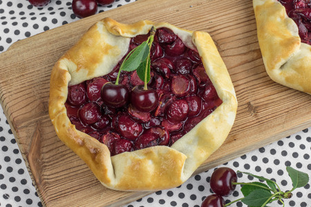 Delicious Rustical Sour Cherry Pie with Sour Cherries on Wooden Boardの写真素材