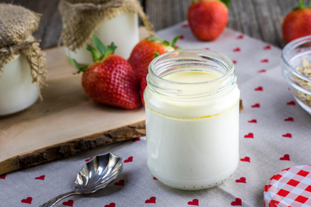 Detail on a open Homemade white yoghurt ripening in the glass jarの写真素材
