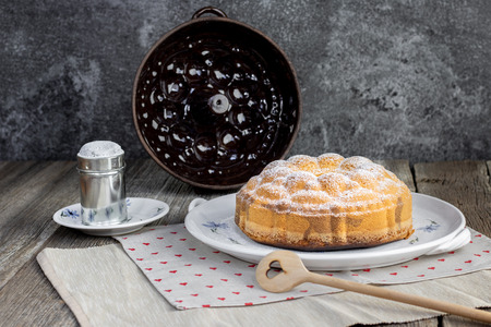 Czech traditional marble bundt cake with sugar bowl on old ceramic dining setの写真素材