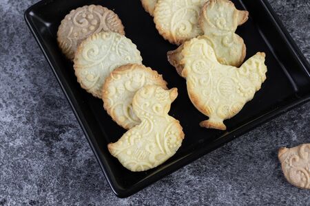 Easter butter biscuits with embossed pattern in black trayの写真素材