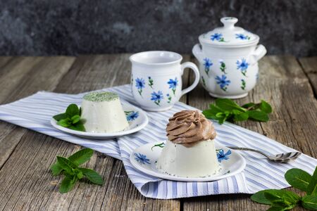 mint panna cotta with chocolate cream set on a old tableの写真素材