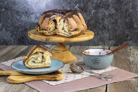 leavened cocoa cake with chocolate set on old wood tableの写真素材