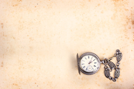 Vintage background with old paper or parchment and pocket watcheの写真素材