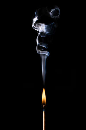 Wooden Matches on fire and smoke on blackの写真素材