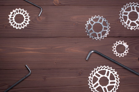 Old bicycle parts and tools on wooden background