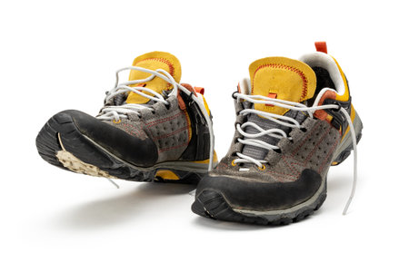Used hiking shoes isolated on white background