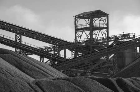 Steel tower and belt conveyors with piles of gravel. Steel structure. Gravel miningの写真素材