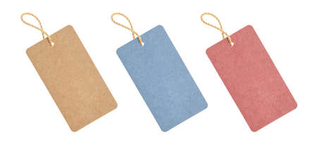 A blank tag tied to hang on a product to display a price or discount. Paper tags on white background.の写真素材