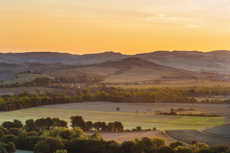 The rising sun over the Tuscan fieldsの写真素材