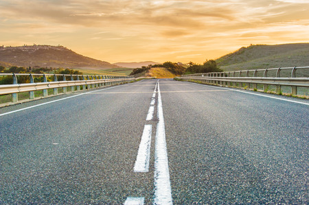 Long road at sunset in the landscapeの写真素材