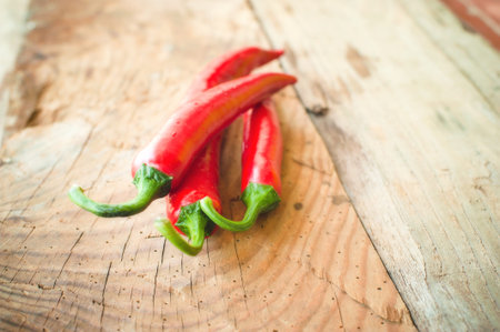 Fresh and spicy chili peppers on a wooden rustic table Vintage