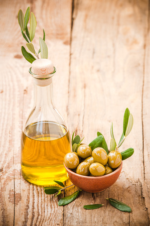 Olives on rustic table in a bowlの写真素材