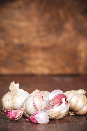 Garlic on a rustic wooden tableの写真素材