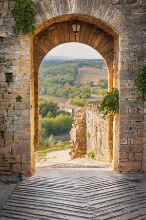 Exit the town of Monteriggioni with views of the Tuscan landscapeの写真素材