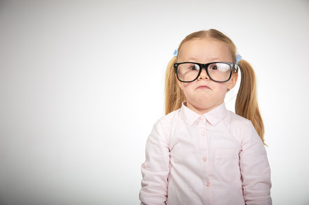 Cute little girl with glasses on a white backgroundの写真素材