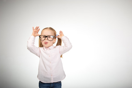 Cute little girl with glasses on a white backgroundの写真素材