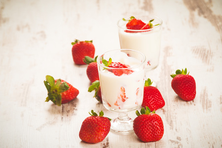Fluffy and full of vitamins healthy strawberries on white wooden rustic table.の写真素材