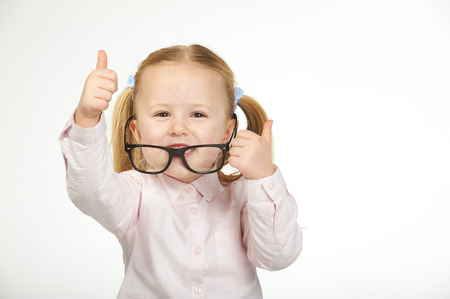 Cute little girl with glasses on a white backgroundの写真素材