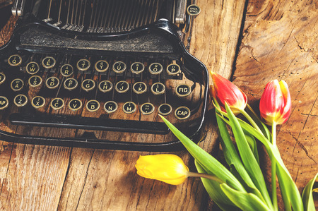 Flowers at the typewriter, writing a romantic letter.の写真素材